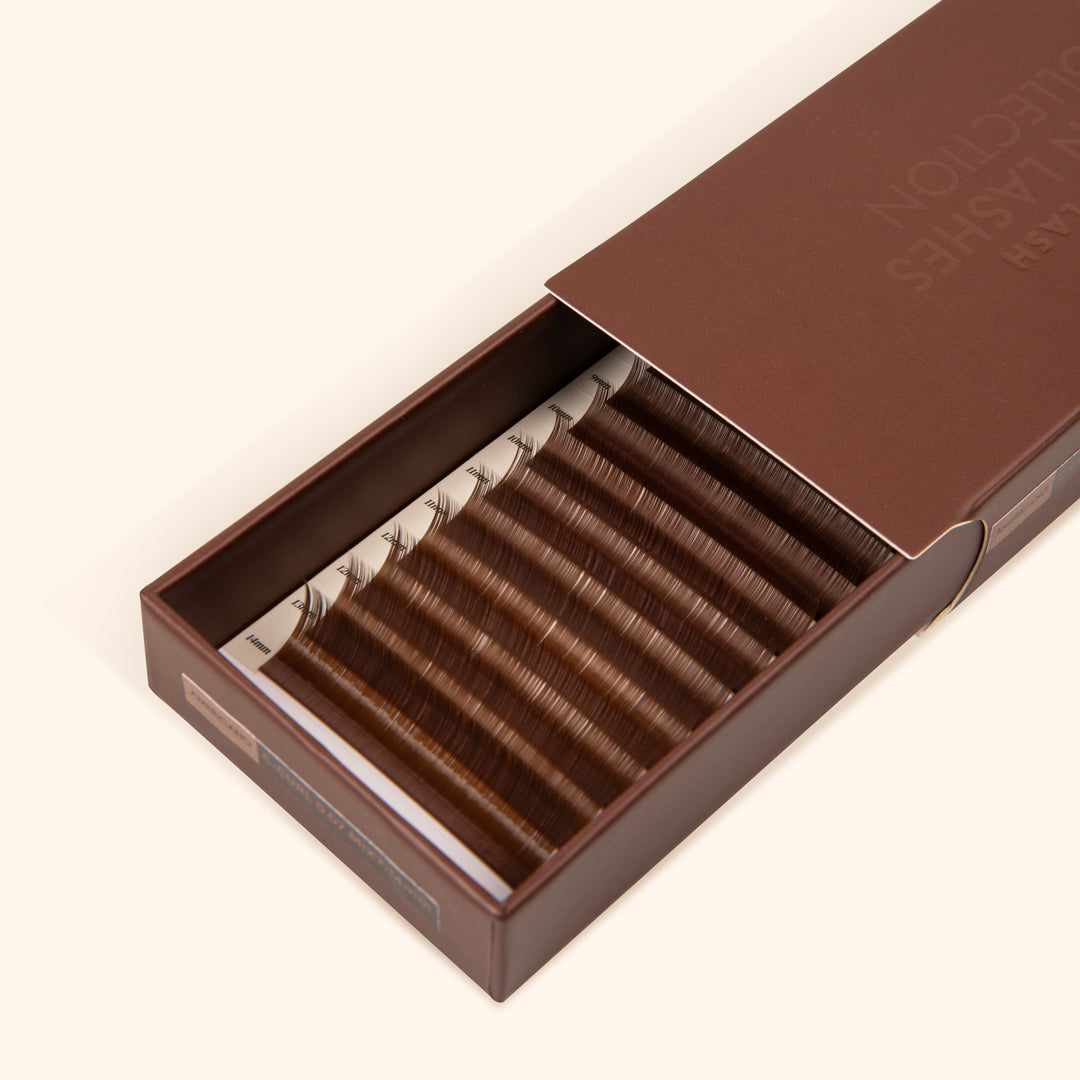 half open brown lash tray showing medium brown eyelash extensions