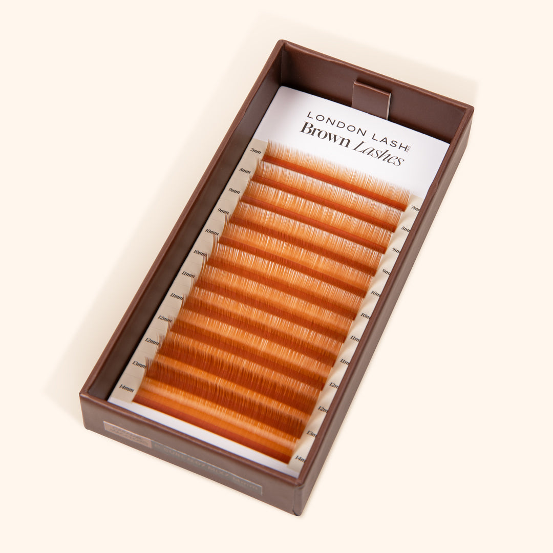 open brown lash tray with light brown lash extension on the lash card inside