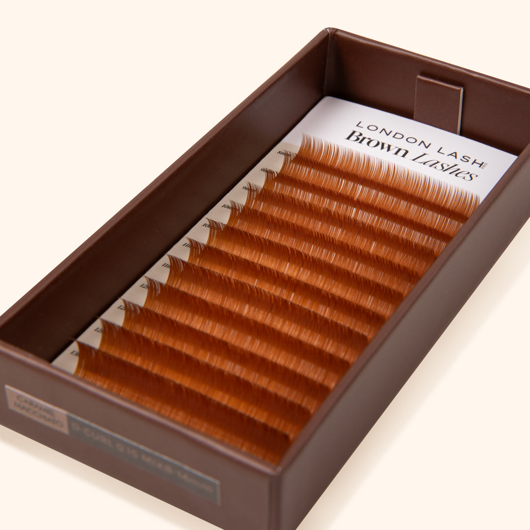 brown paper lash tray with ginger brown lash extensions on the lash card 