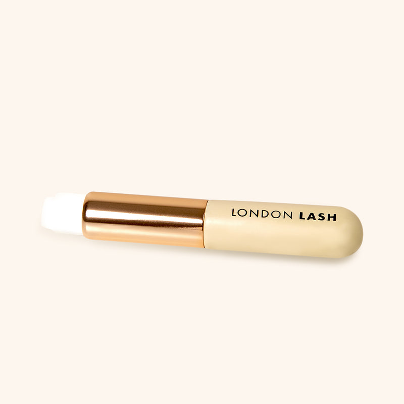 lash cleansing brush with white soft synthetic fiber and metallic gold and wooden beige handle